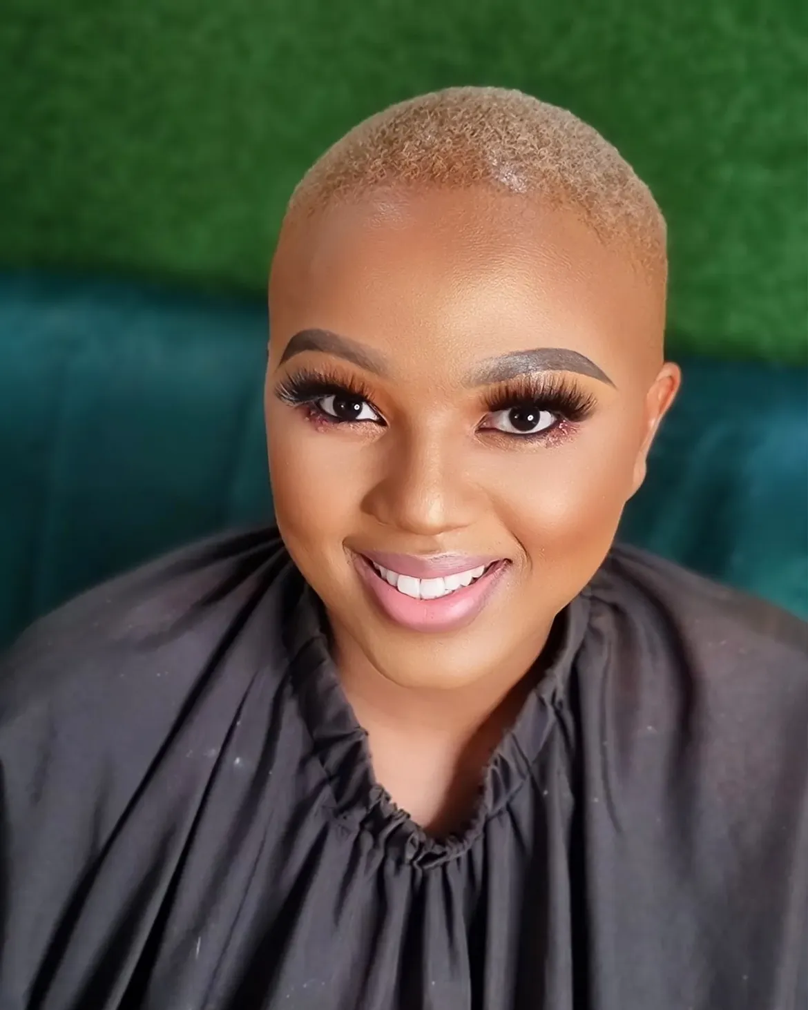 Striking cropped platinum blonde hair paired with full flutter lashes and pink gloss