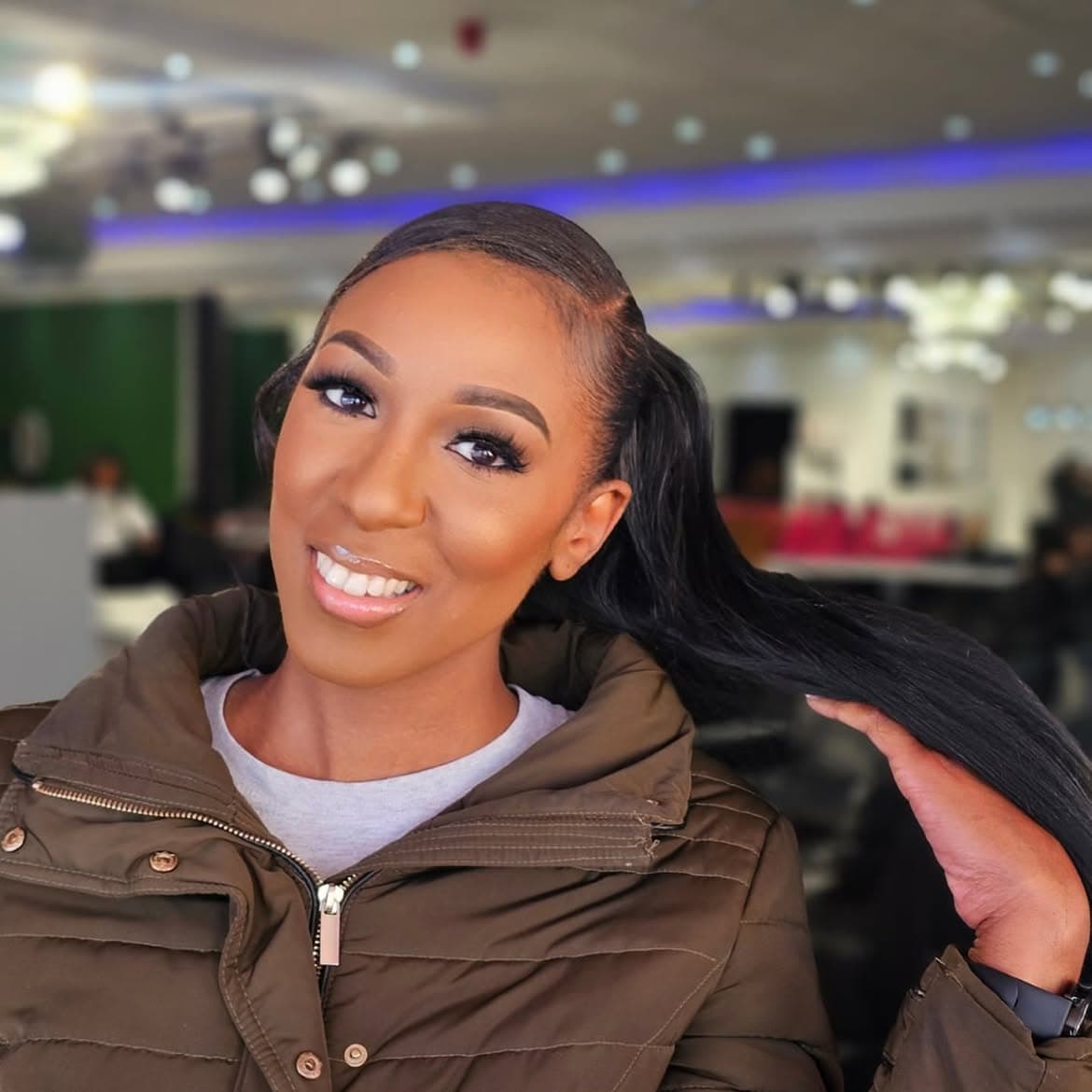 Camera-ready warm foundation finish with sleek ponytail extension and glossy lip